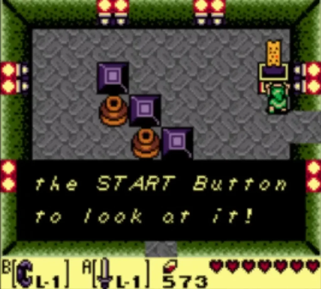 Link holds up the Dungeon Map; box ends 'the START Button to look at it!' Link holds up the Dungeon Map; box ends 'the START Button to look at it!'