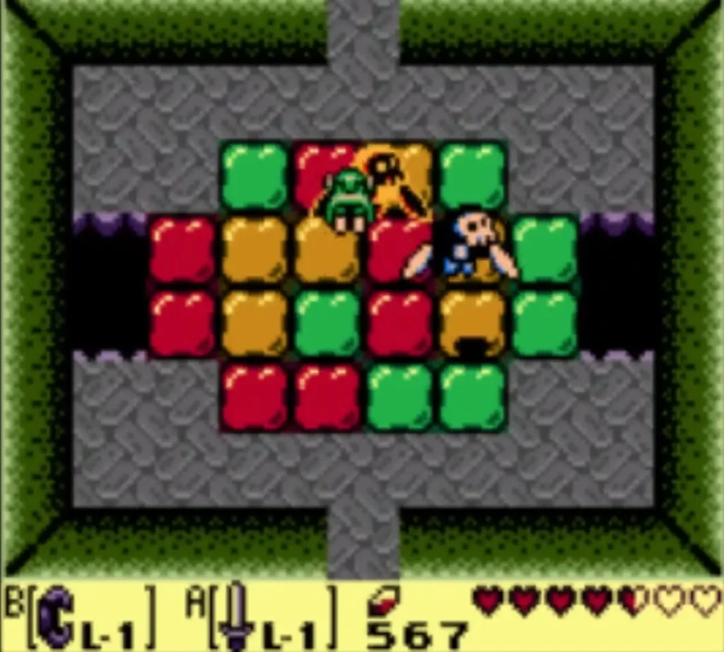 Link stands in a room of green, orange and red tiles with an enemy among them Link stands in a room of green, orange and red tiles with an enemy among them