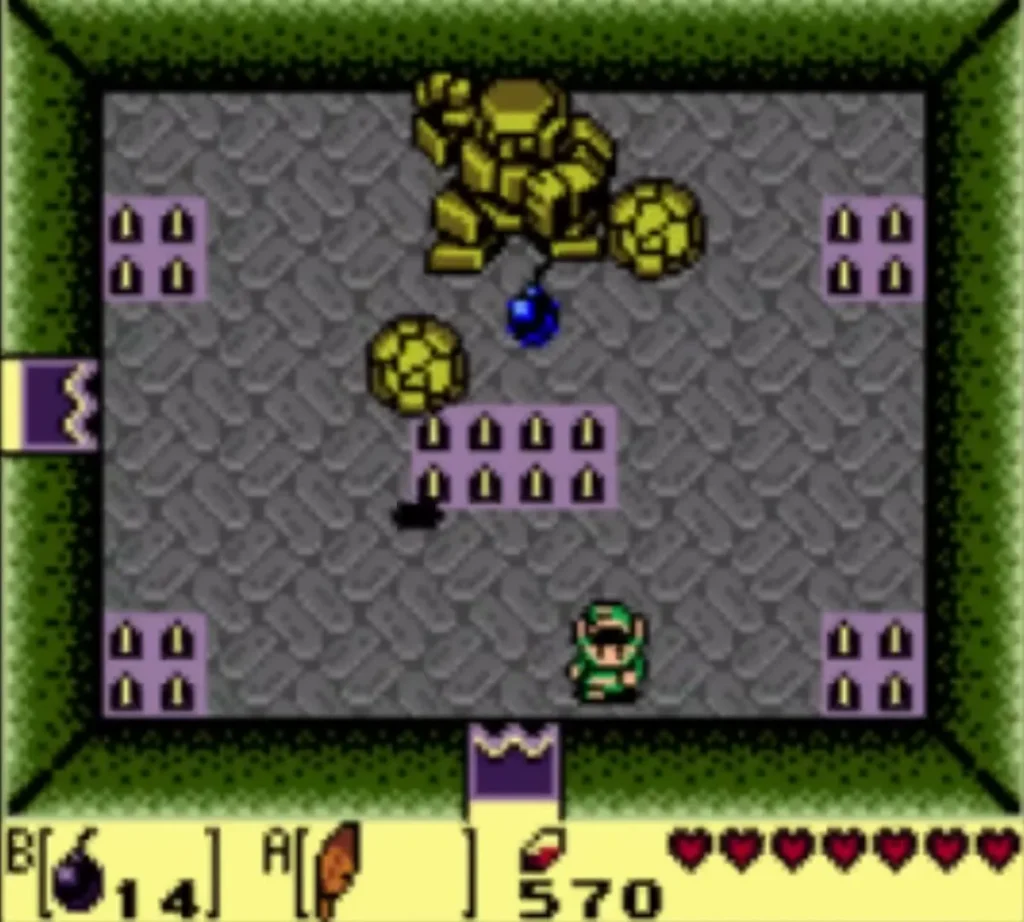 Stone Hinox stomps at the top of the room while a bomb sits on the floor and Link waits at the lower right Stone Hinox stomps at the top of the room while a bomb sits on the floor and Link waits at the lower right