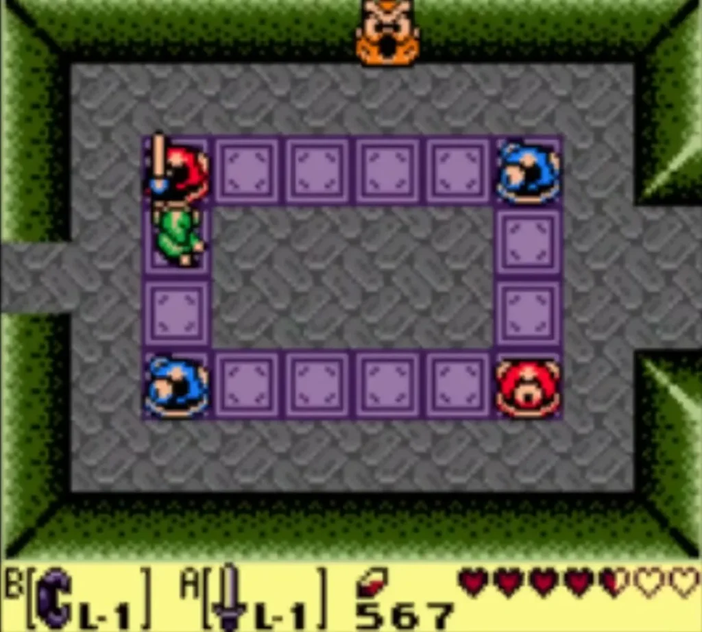 Link beside a red and blue statue ring in the owl statue room, with the owl above Link beside a red and blue statue ring in the owl statue room, with the owl above