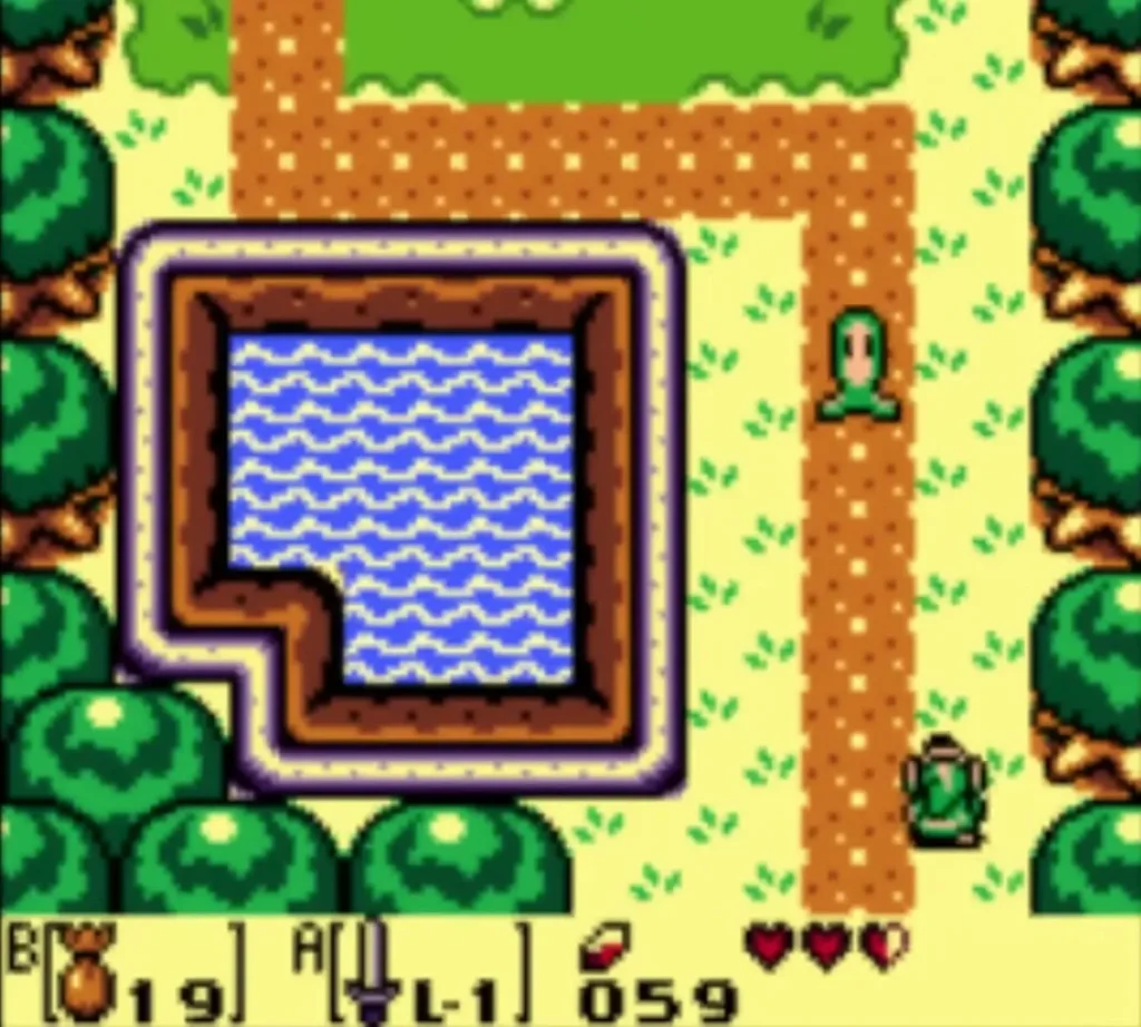 A green Buzz Blob standing on the dirt path beside a square pond while Link walks the same path A green Buzz Blob standing on the dirt path beside a square pond while Link walks the same path