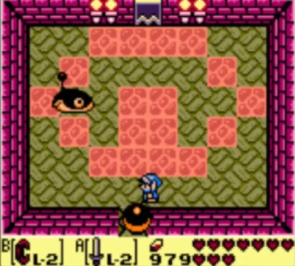 Black iron ball with an orange rim rolling toward Link across a brick dungeon room Black iron ball with an orange rim rolling toward Link across a brick dungeon room