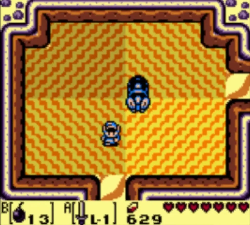 Lanmola's head rises from the sand beside Link in the sandy cave room Lanmola's head rises from the sand beside Link in the sandy cave room