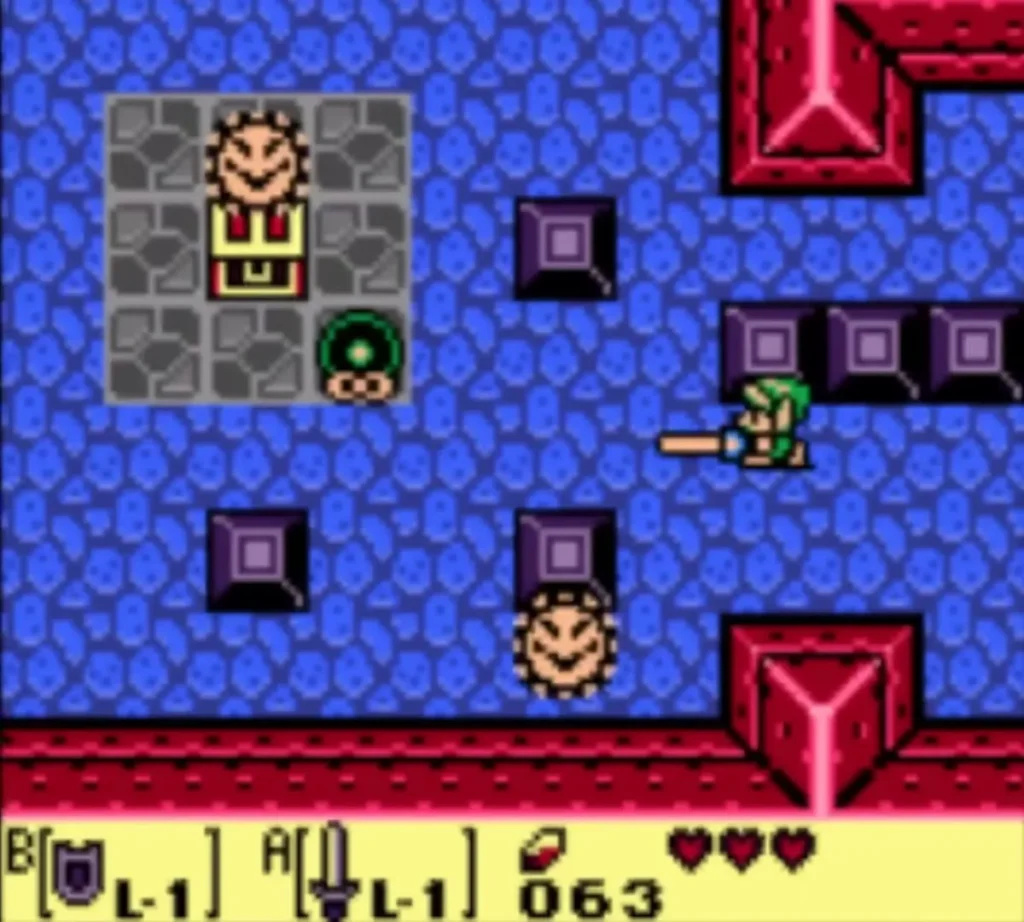 A Mini-Moldorm wriggling beside a chest in Tail Cave as Link's Sword reaches out A Mini-Moldorm wriggling beside a chest in Tail Cave as Link's Sword reaches out