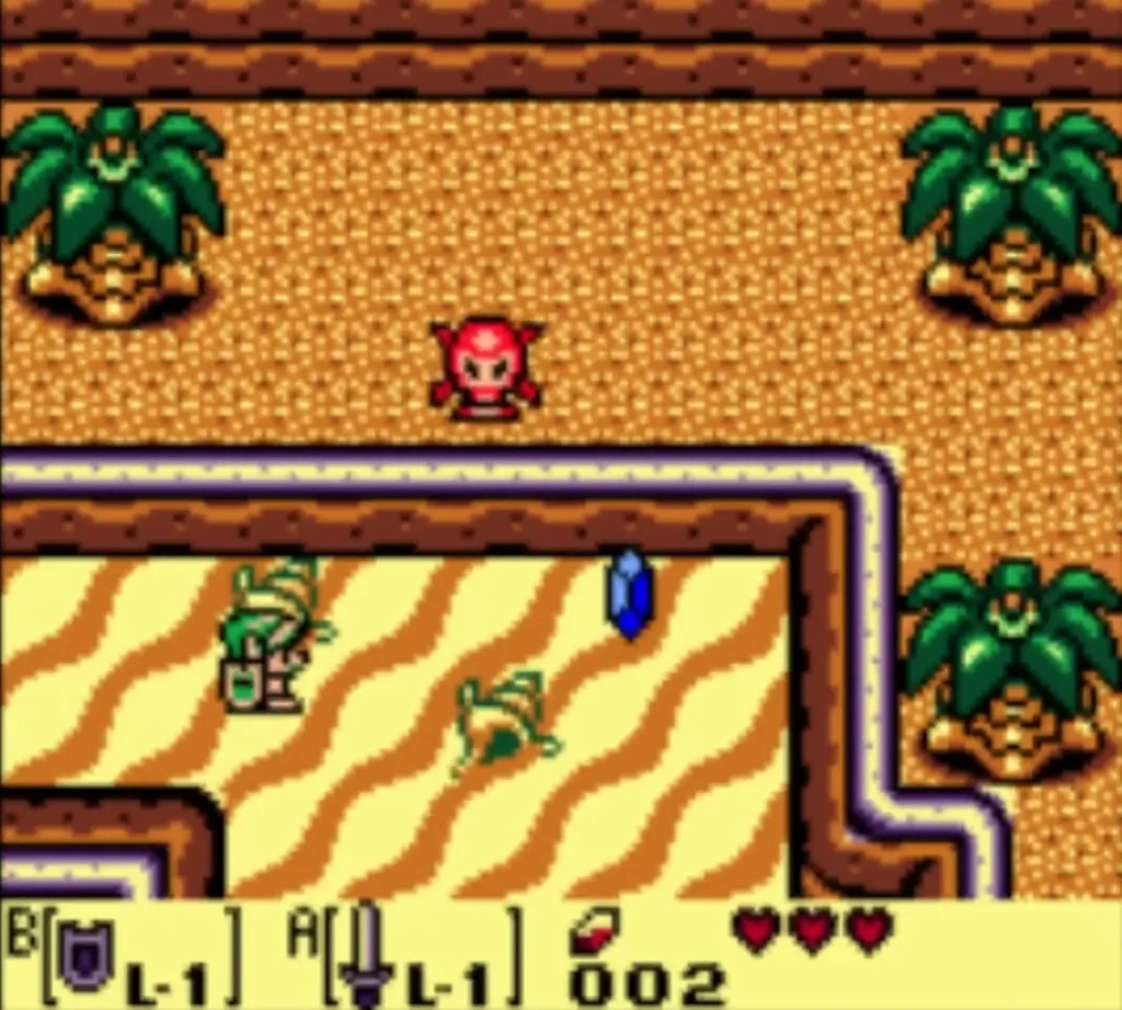 Red Octorok on the sand of Toronbo Shores above Link, with a blue rupee nearby Red Octorok on the sand of Toronbo Shores above Link, with a blue rupee nearby