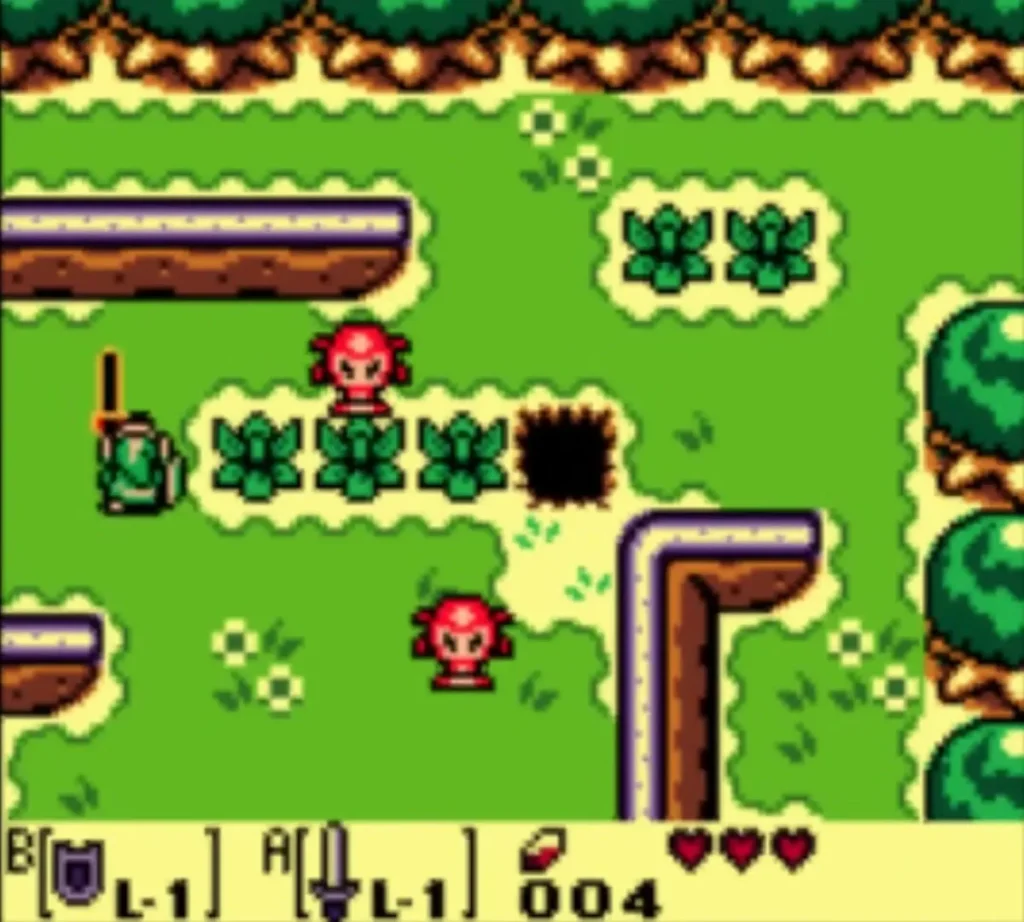 Link with his Sword facing two red Octoroks beside a hole in a grassy field Link with his Sword facing two red Octoroks beside a hole in a grassy field