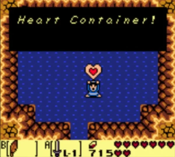 Link holds a new Heart Container over his head as the Heart Container message fills the box Link holds a new Heart Container over his head as the Heart Container message fills the box