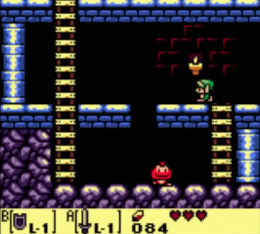 Link on a ledge in an underground Tail Cave passage with ladders, a torch and a red enemy below Link on a ledge in an underground Tail Cave passage with ladders, a torch and a red enemy below