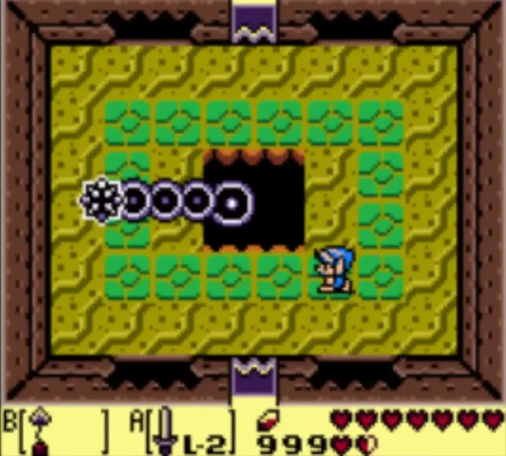 The Slime Eel's spiked tail sweeps around the central pit while Link stands at its edge The Slime Eel's spiked tail sweeps around the central pit while Link stands at its edge