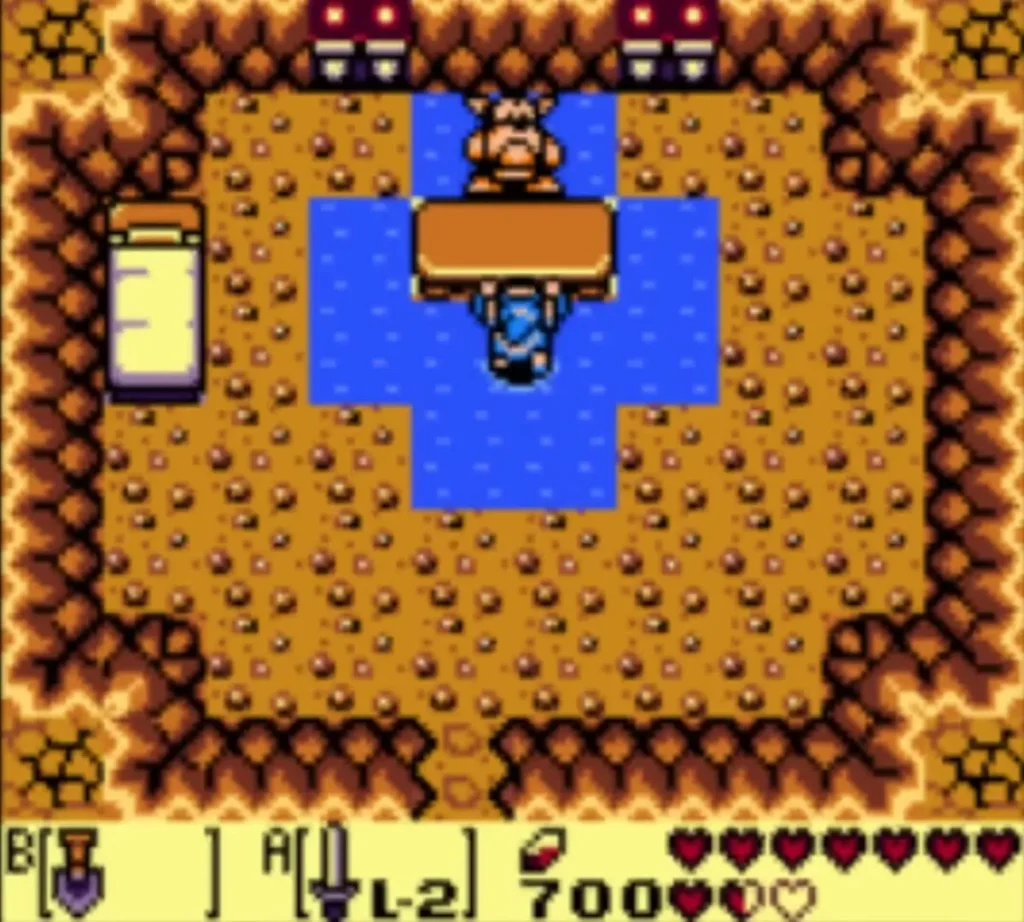 Goriya standing behind his table in the cave with Link in the water