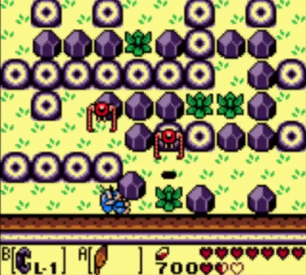 Link walking through the ring and boulder maze with red enemies nearby