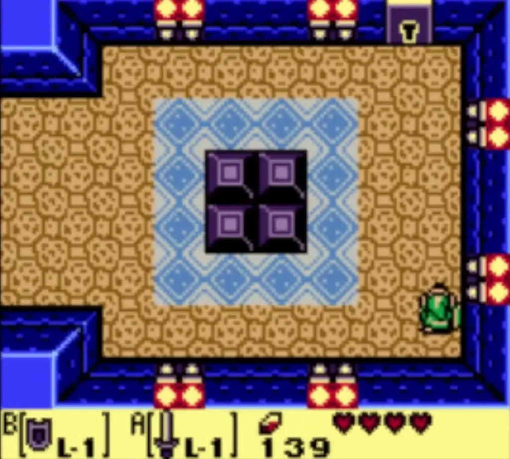 Link at the east side of the block-pushing room beside the purple blocks and blue tiles Link at the east side of the block-pushing room beside the purple blocks and blue tiles