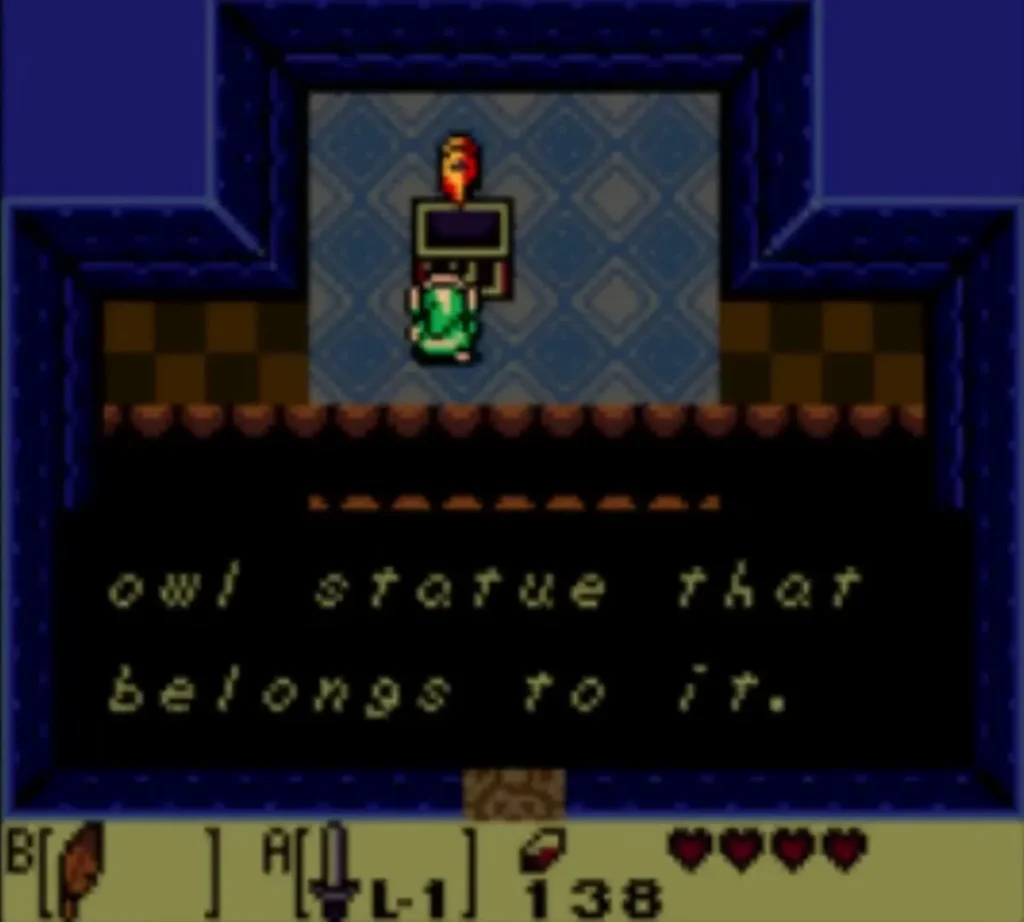 The owl statue hint box reading owl statue that belongs to it. is fully typed as Link stands at the statue The owl statue hint box reading owl statue that belongs to it. is fully typed as Link stands at the statue