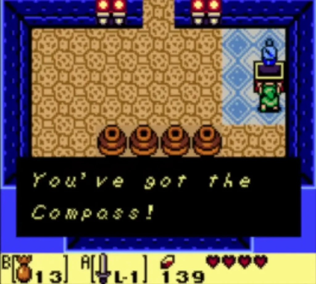 Message box reading You've got the Compass! fully typed as Link holds the Compass above his head Message box reading You've got the Compass! fully typed as Link holds the Compass above his head