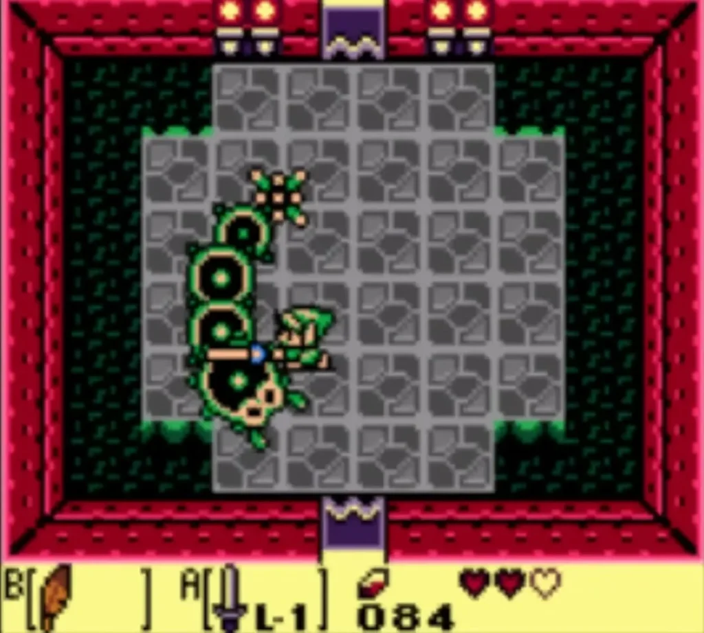 Link's Sword reaches into Moldorm's coiled body on the left of the grey stone floor Link's Sword reaches into Moldorm's coiled body on the left of the grey stone floor