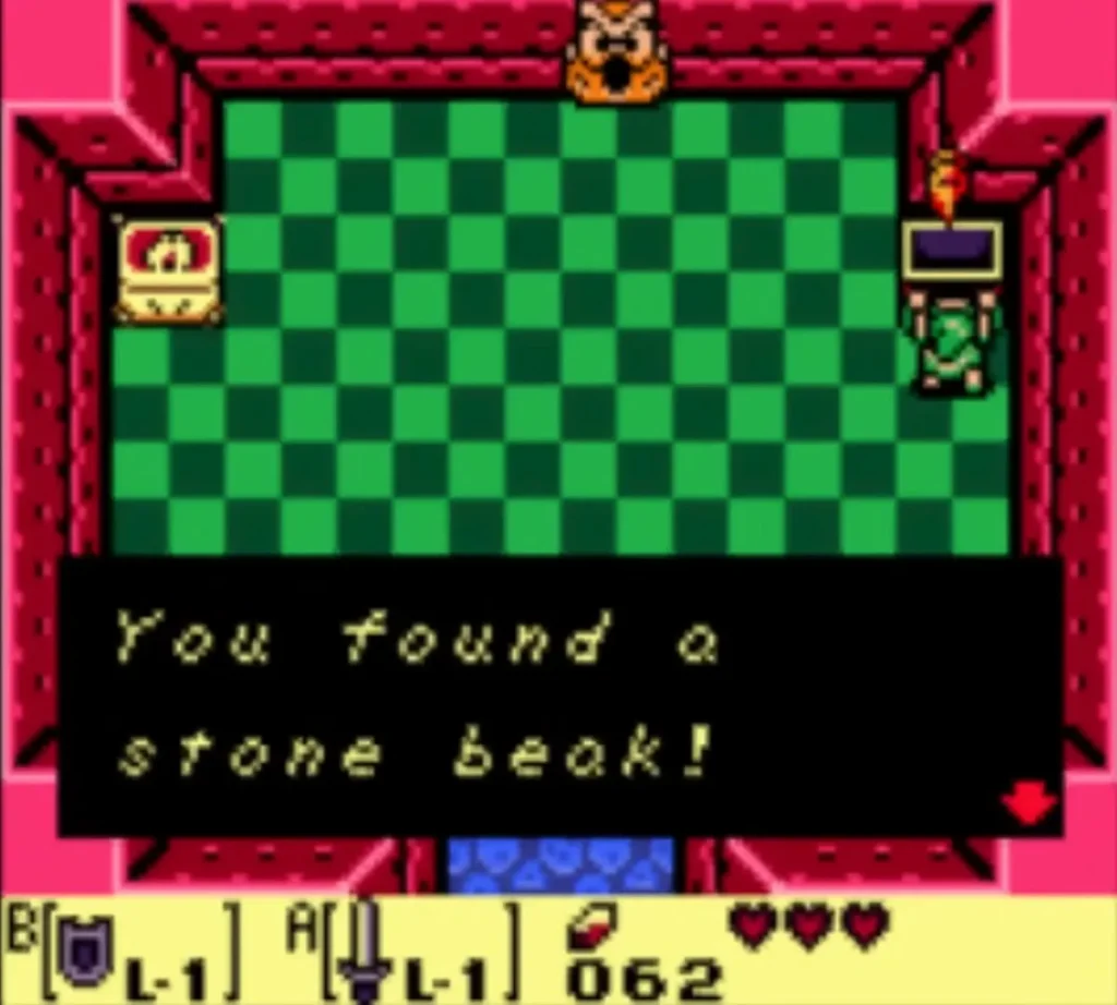 A message box reading You found a stone beak! is fully typed in the checkered room A message box reading You found a stone beak! is fully typed in the checkered room