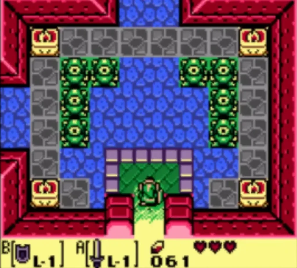Link stands inside the Tail Cave entrance room between the green statues after the gate opens Link stands inside the Tail Cave entrance room between the green statues after the gate opens