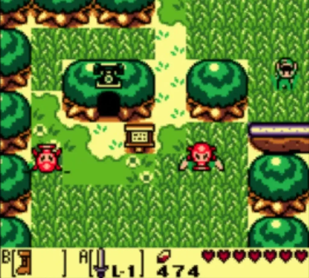 The telephone booth set in a hollow tree, with a red Octorok on the grass path nearby The telephone booth set in a hollow tree, with a red Octorok on the grass path nearby