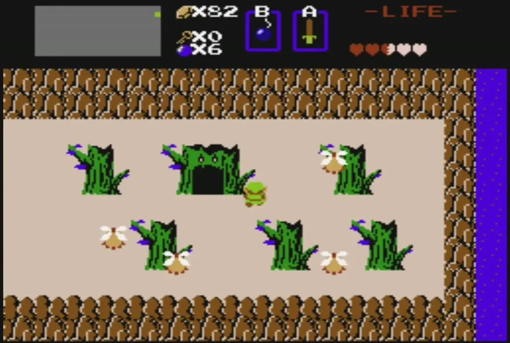Green Armos statues in a group beside a dark cave entrance on the overworld