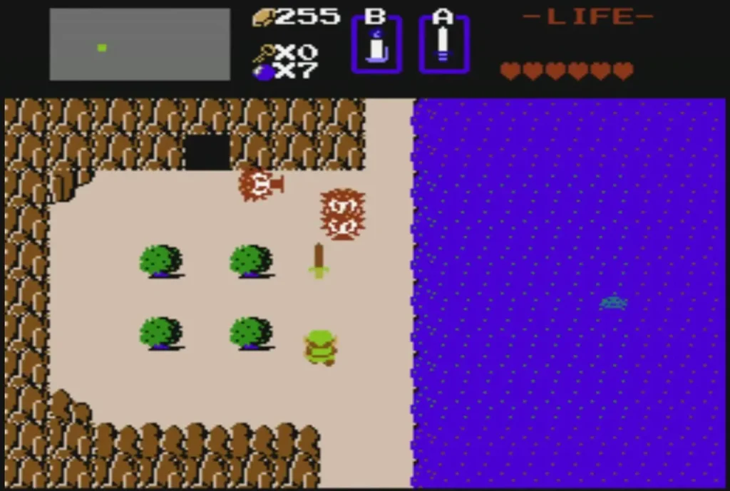 Green Zol blob beside a tree on the shore of a lake