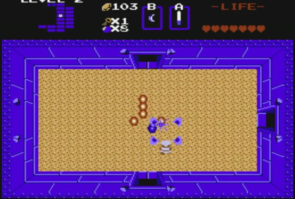 Orange ring segments of a Moldorm crawling across a Level 2 sand room
