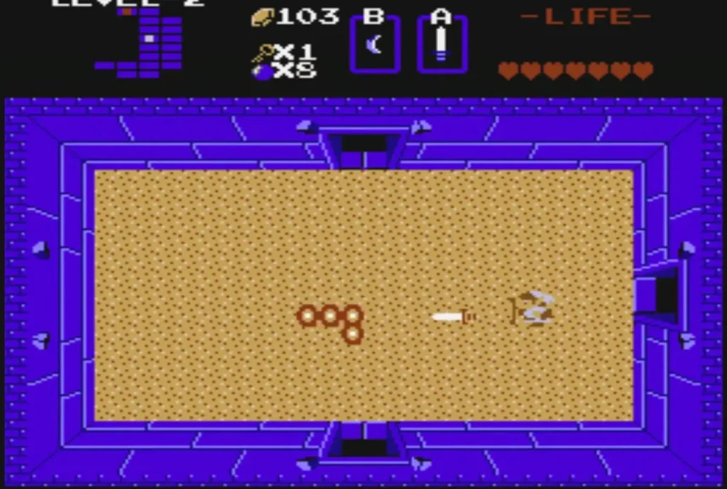 Orange ring segments of a Moldorm crawling across a sand room