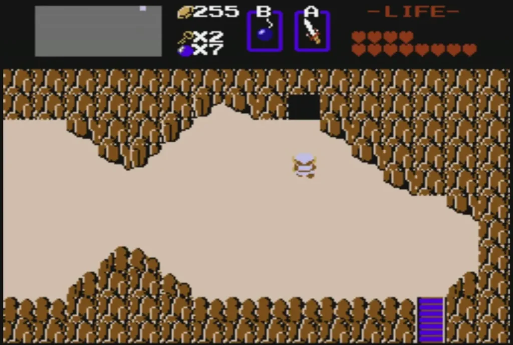 Rock wall opened by a bomb, revealing a dark cave entrance Rock wall opened by a bomb, revealing a dark cave entrance