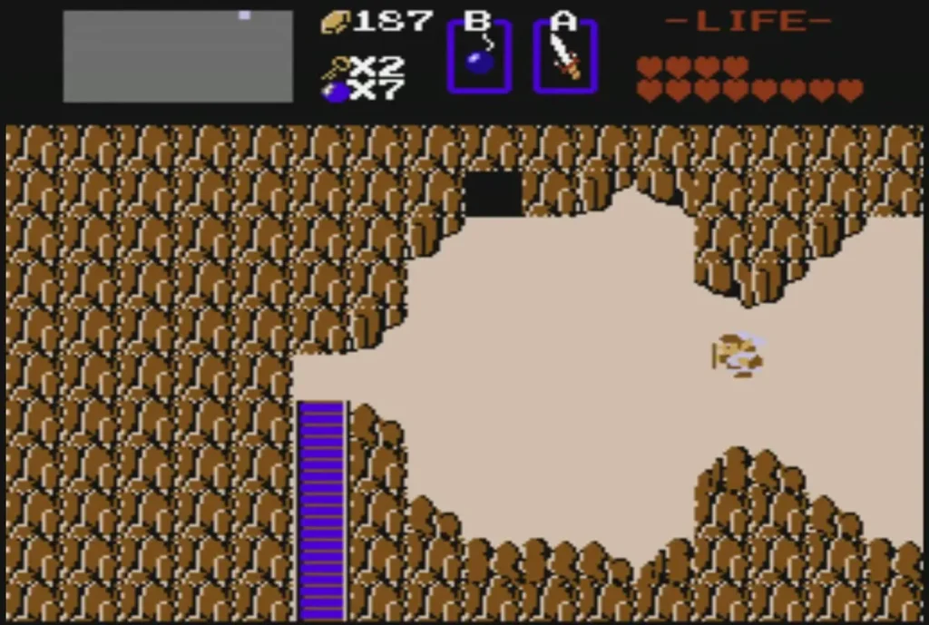Rock-walled path with a dark cave above and a purple gate below Rock-walled path with a dark cave above and a purple gate below