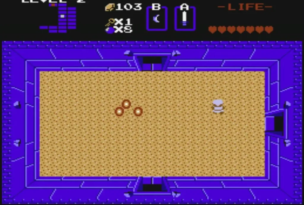 Moldorm segments crawling across the sand room while Link stands at the east side Moldorm segments crawling across the sand room while Link stands at the east side