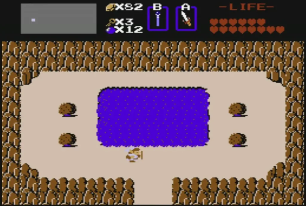 Link walks across the sand toward the purple lake with four boulders Link walks across the sand toward the purple lake with four boulders