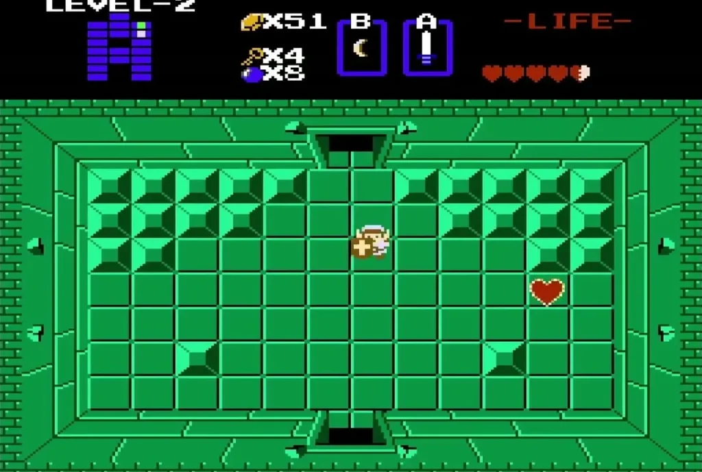 Link in the Level 2 boss room beside a Heart Container on the floor Link in the Level 2 boss room beside a Heart Container on the floor
