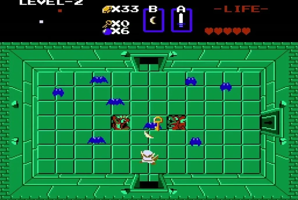Link among blue keese and red trap blocks in the green Level 2 room with a key on the floor Link among blue keese and red trap blocks in the green Level 2 room with a key on the floor