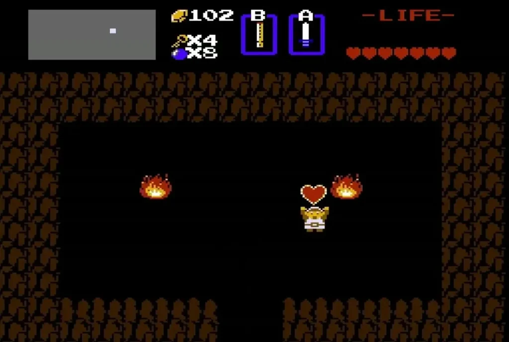 Link holding up the Heart Container in the cave with fires Link holding up the Heart Container in the cave with fires