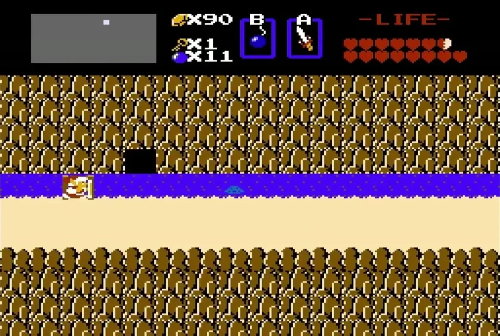 Black cave opening in the cliff above the river after a bomb Black cave opening in the cliff above the river after a bomb