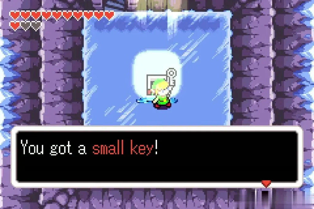 Link holding up a small key after the item-get message in the Temple of Droplets ice room Link holding up a small key after the item-get message in the Temple of Droplets ice room