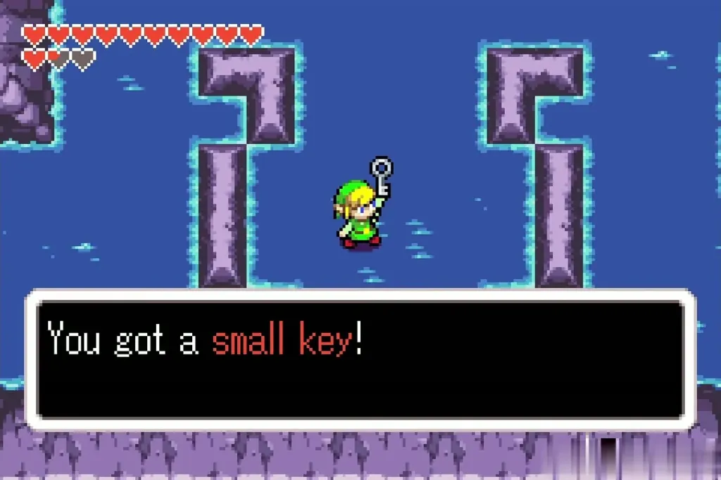 Link holding up a small key after the item-get message in the Temple of Droplets water room Link holding up a small key after the item-get message in the Temple of Droplets water room