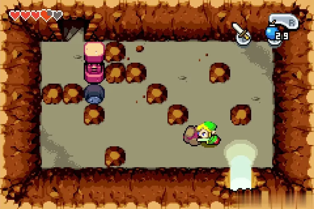 Link pushing a round boulder through the cave toward the pit Link pushing a round boulder through the cave toward the pit