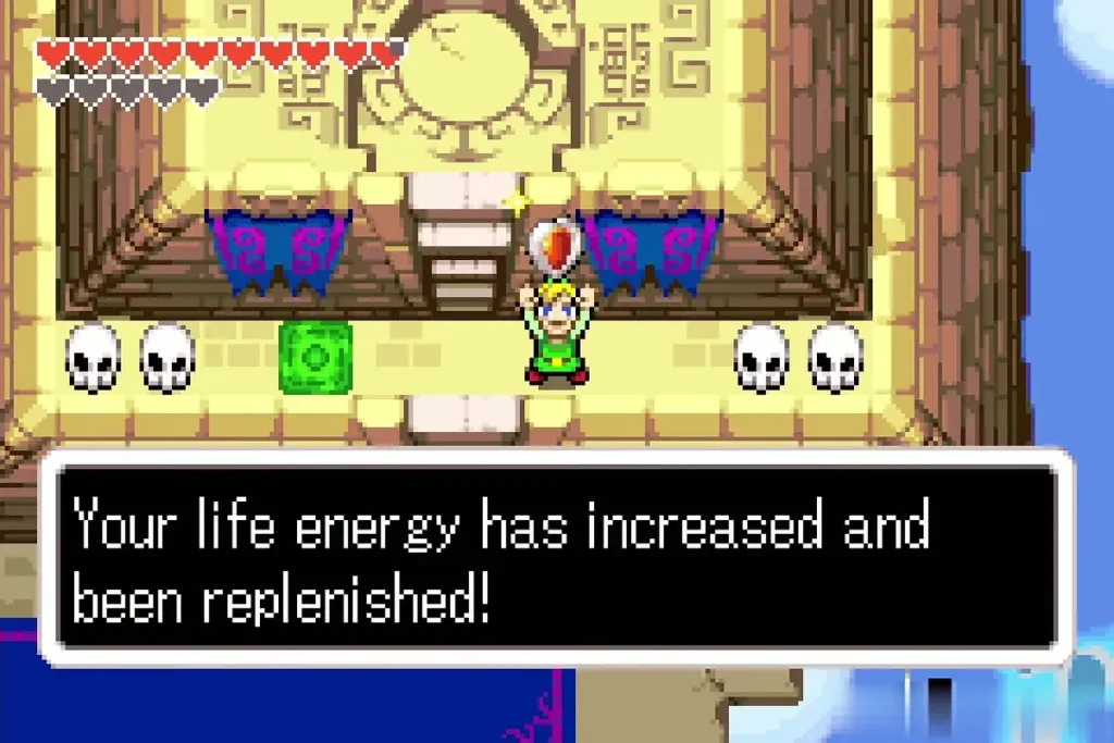 Link holding the Heart Container as the text says his life is replenished Link holding the Heart Container as the text says his life is replenished