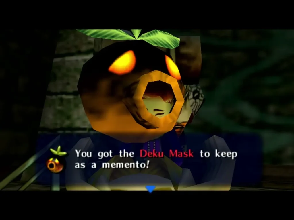 Link holds the Deku Mask, the box reading You got the Deku Mask to keep as a memento Link holds the Deku Mask, the box reading You got the Deku Mask to keep as a memento