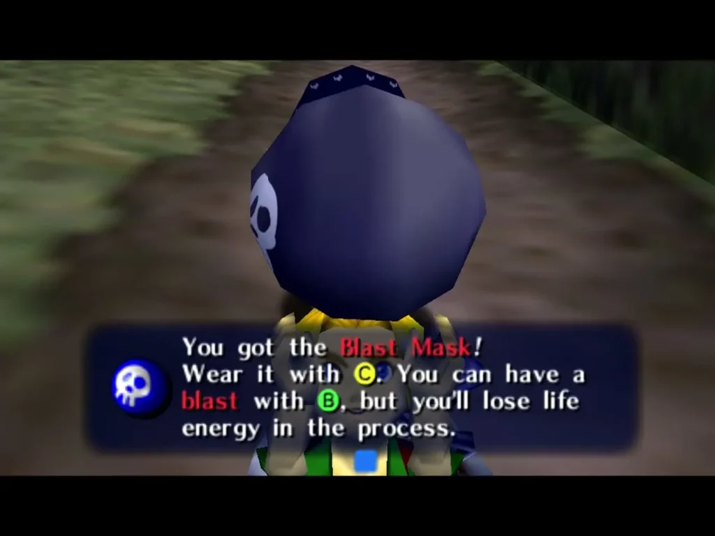Link wearing the Blast Mask seen from behind as the box says he can blast with B, losing life energy Link wearing the Blast Mask seen from behind as the box says he can blast with B, losing life energy