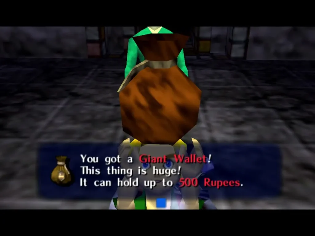 Link holds up the Giant Wallet, the box reading it can hold up to 500 Rupees Link holds up the Giant Wallet, the box reading it can hold up to 500 Rupees