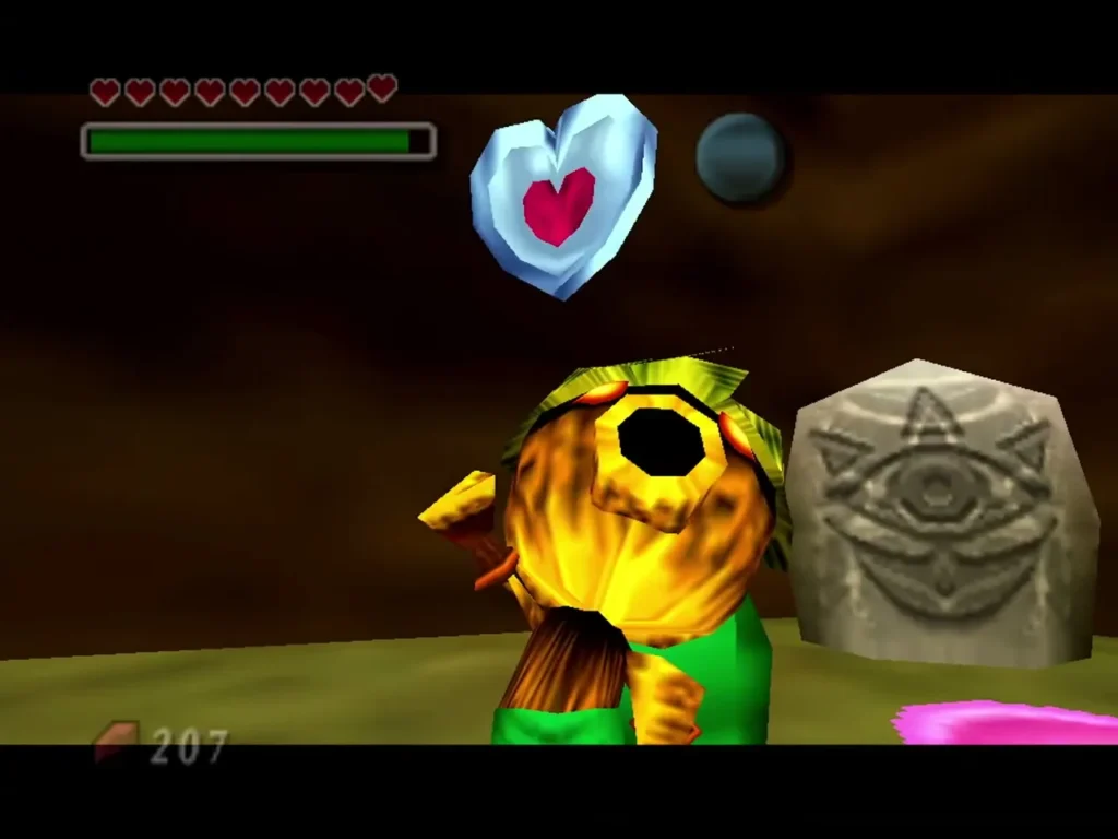 Deku Link beside a stone eye carving with the piece of heart floating above him Deku Link beside a stone eye carving with the piece of heart floating above him