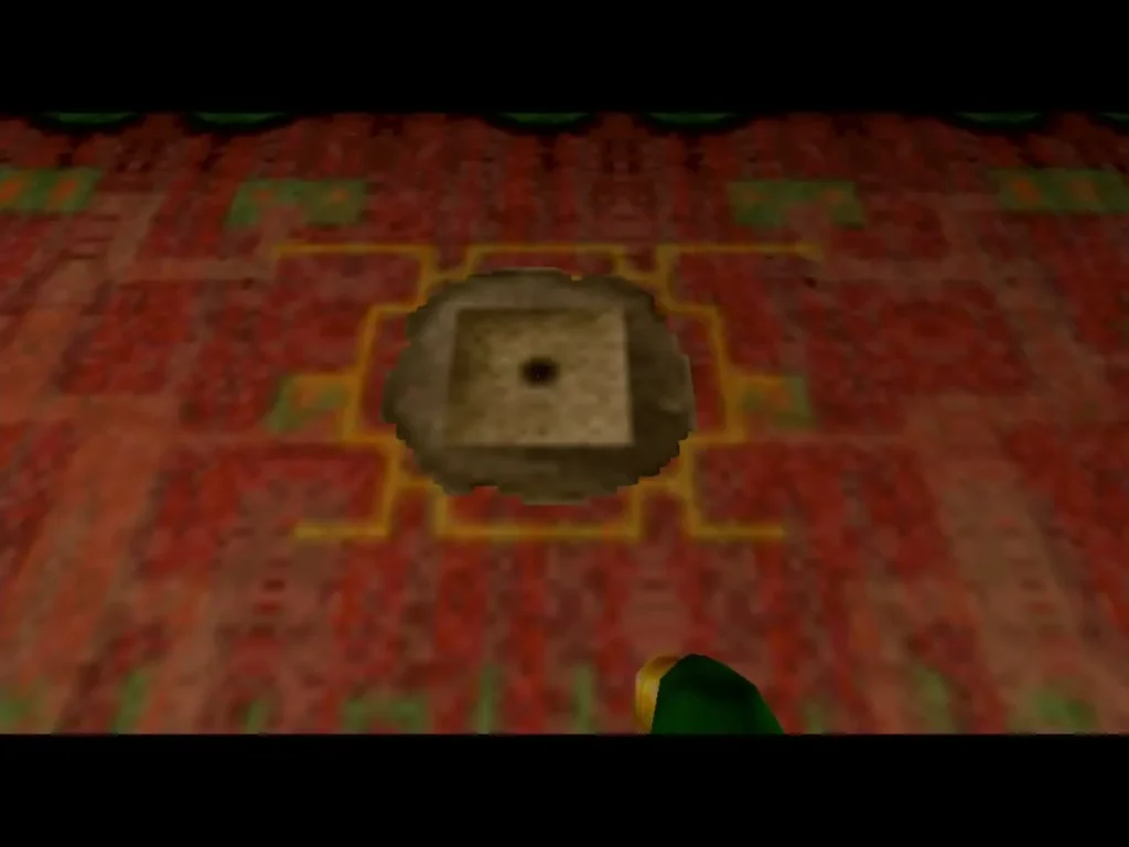 A patch of soft soil set into the red patterned floor of the spider house A patch of soft soil set into the red patterned floor of the spider house