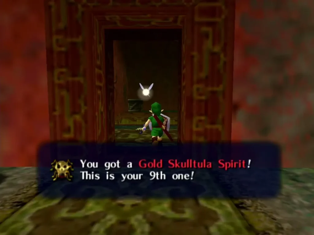 Link in a red doorway after taking his 9th Gold Skulltula Spirit, the box reading This is your 9th one Link in a red doorway after taking his 9th Gold Skulltula Spirit, the box reading This is your 9th one