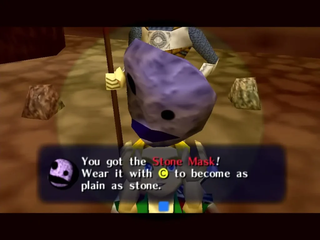 The Stone Mask held aloft as the box explains that wearing it makes him as plain as stone The Stone Mask held aloft as the box explains that wearing it makes him as plain as stone