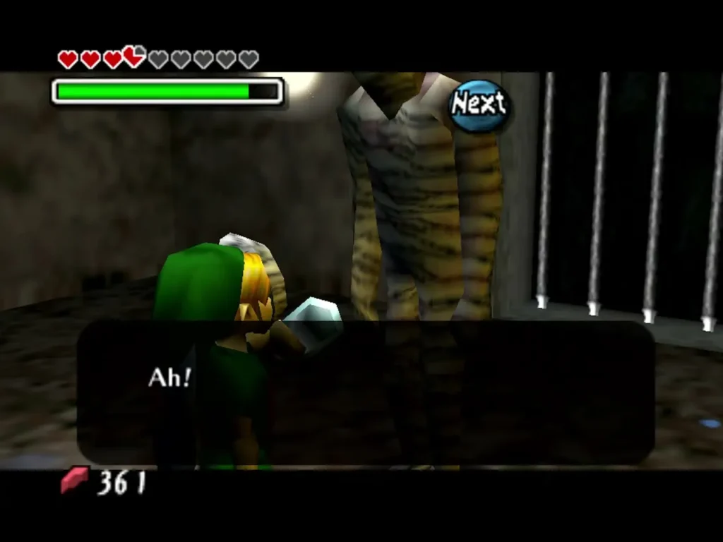 Link holds a bottle out to a Gibdo in a barred cell, the box reading Ah! Link holds a bottle out to a Gibdo in a barred cell, the box reading Ah!