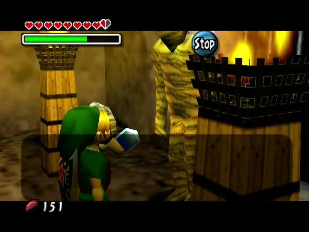 Link holds a small item out toward the Gibdo beside a torch-lit cage Link holds a small item out toward the Gibdo beside a torch-lit cage