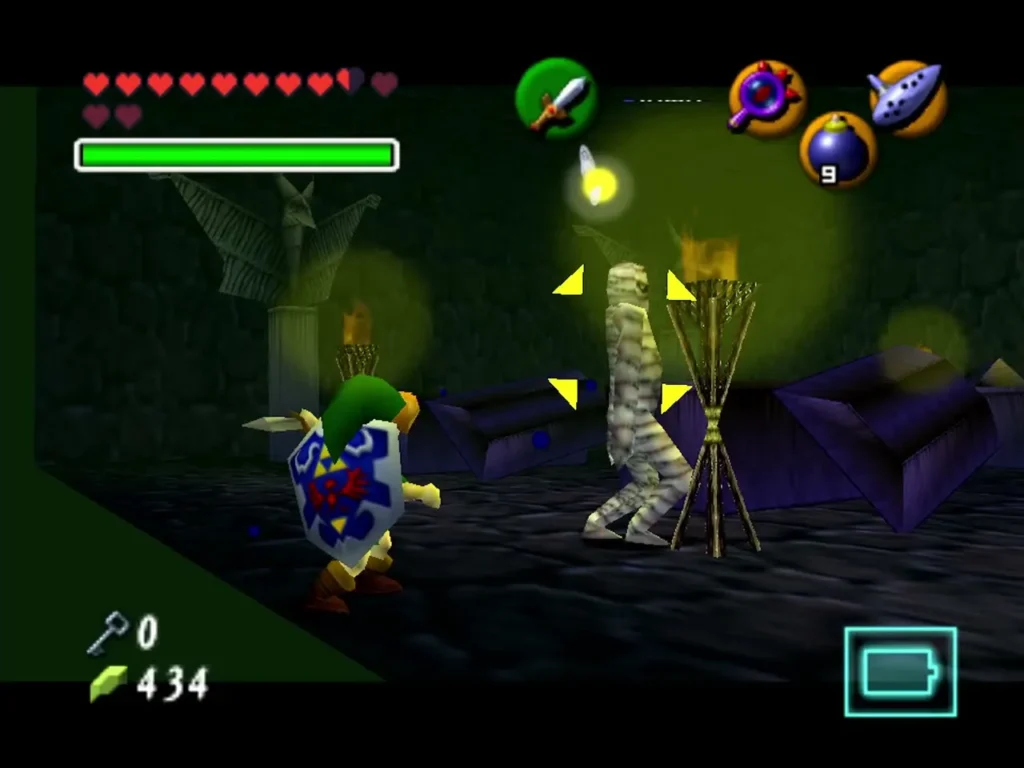 Link facing a Gibdo mummy locked on in a torch-lit dungeon room
