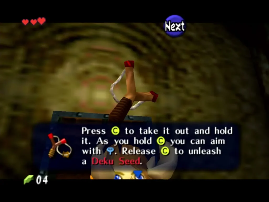 Link with the Fairy Slingshot and the box explaining how to fire a Deku Seed Link with the Fairy Slingshot and the box explaining how to fire a Deku Seed