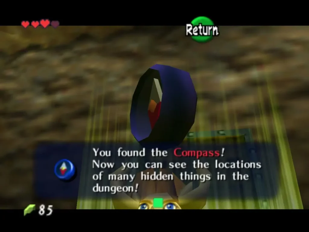 Link holding up the Compass after the chest opens, with the You found the Compass box